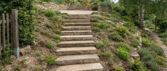 Stufen in einen Gartenhang gebaut, führen zu einer erhöhten Terrasse